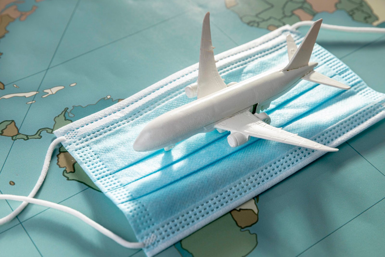high-angle-airplane-figurine-medical-mask